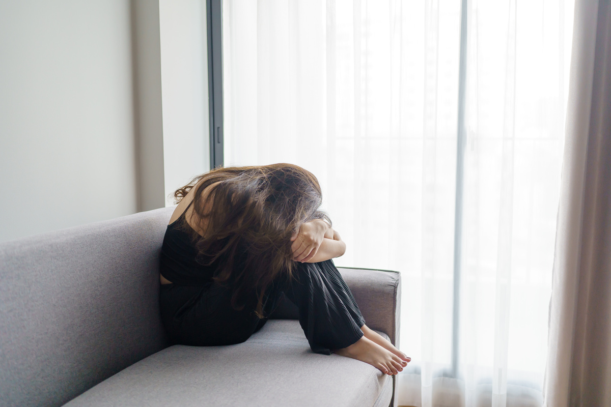 Sad Woman Thinking about Problems Sitting on a Sofa Upset Girl F